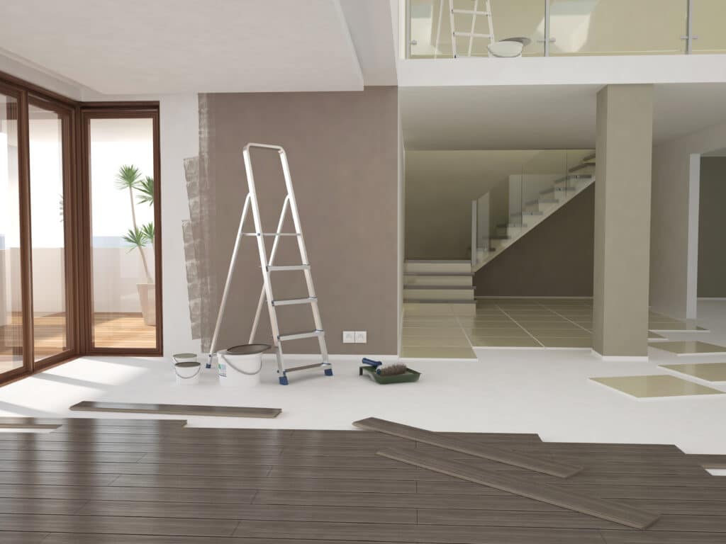 Rénovation Maison Moderne : Peinture & Pose Parquet Intérieur de maison moderne en rénovation. Un mur est partiellement peint en brun, du parquet foncé est en cours de pose, avec échelle et matériel.